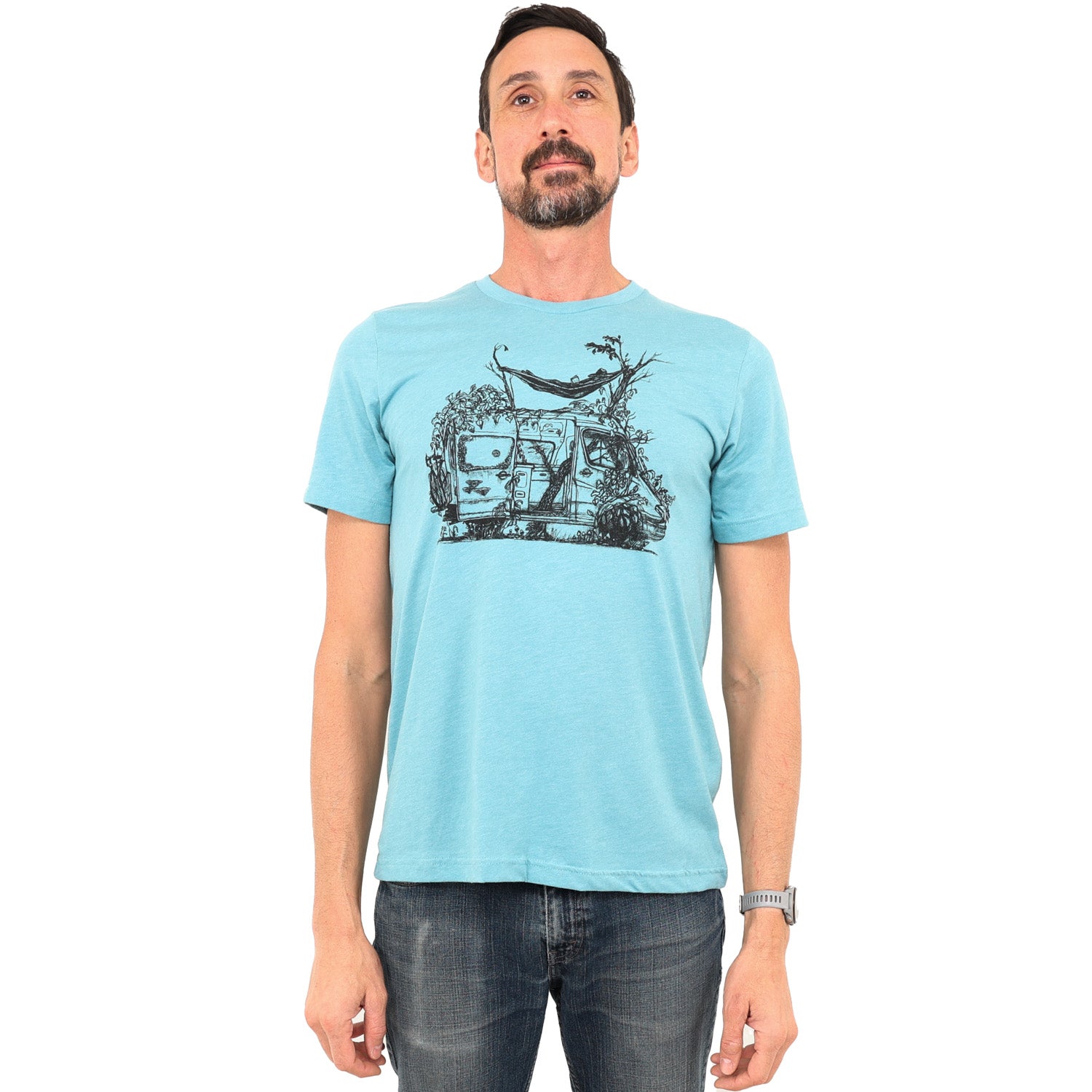 blue t-shirt with delapadated camper being taken back by earth. Tree growing right up the center of the van with person laying in hammock above sprinter like van