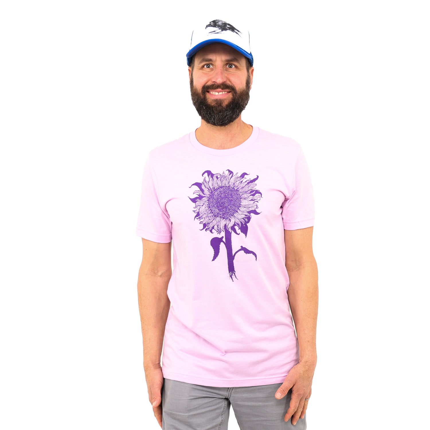 man standing in white background while a pinkish/purple t-shirt with dark purple ink of an intricate sunflower