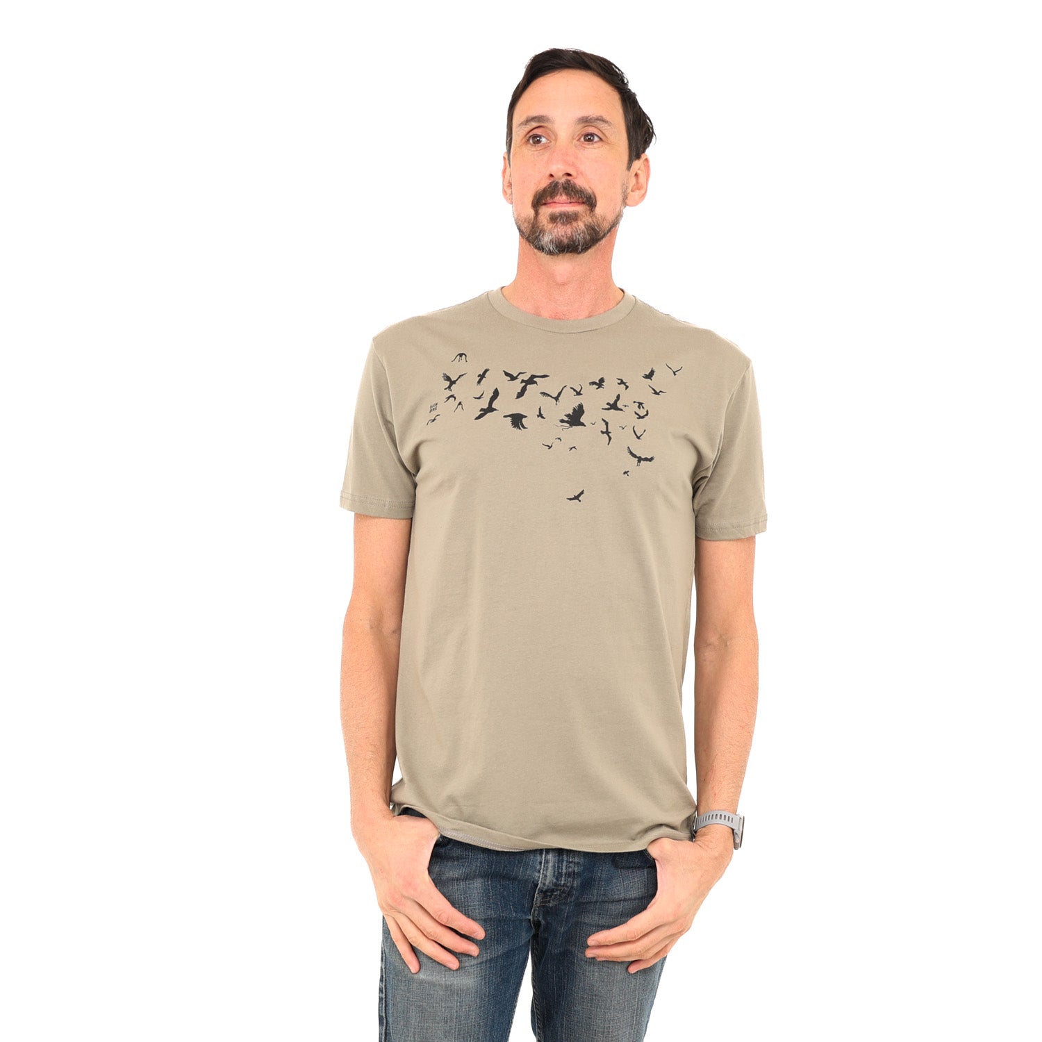 man wearing light brown/tan-ish t-shirt with black ink of birds flying across his chest