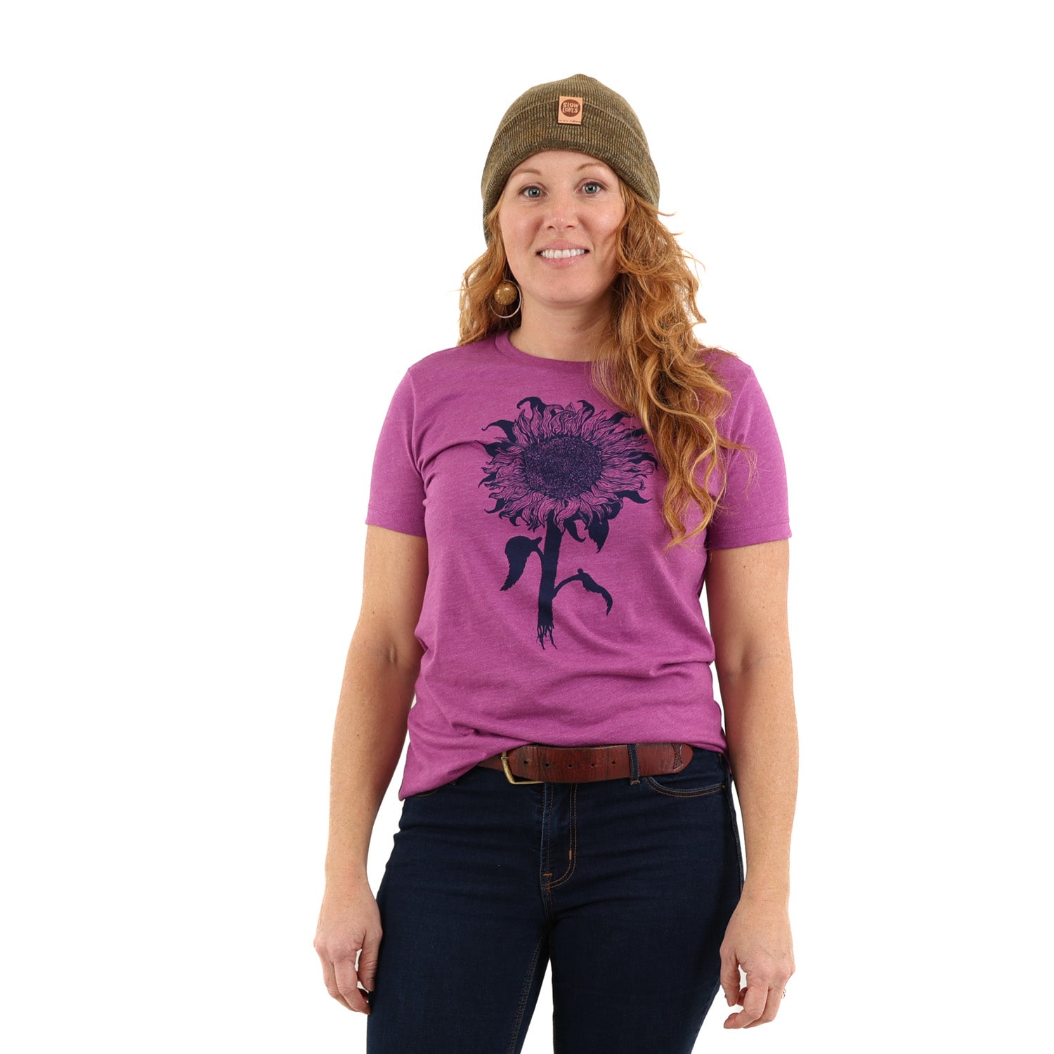 Woman wearing purple tinted pink shirt with a sunflower printed in