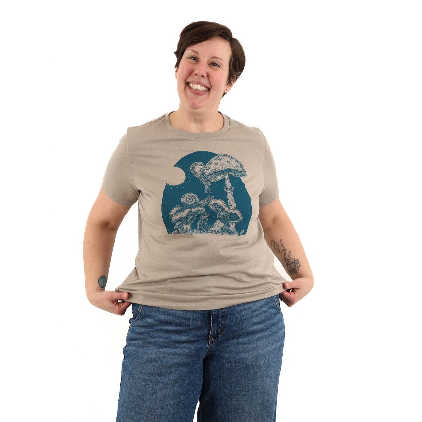 woman wearing tan/brown colored t shirt with blue ink of the full moon buffet slow loris t shirt.
