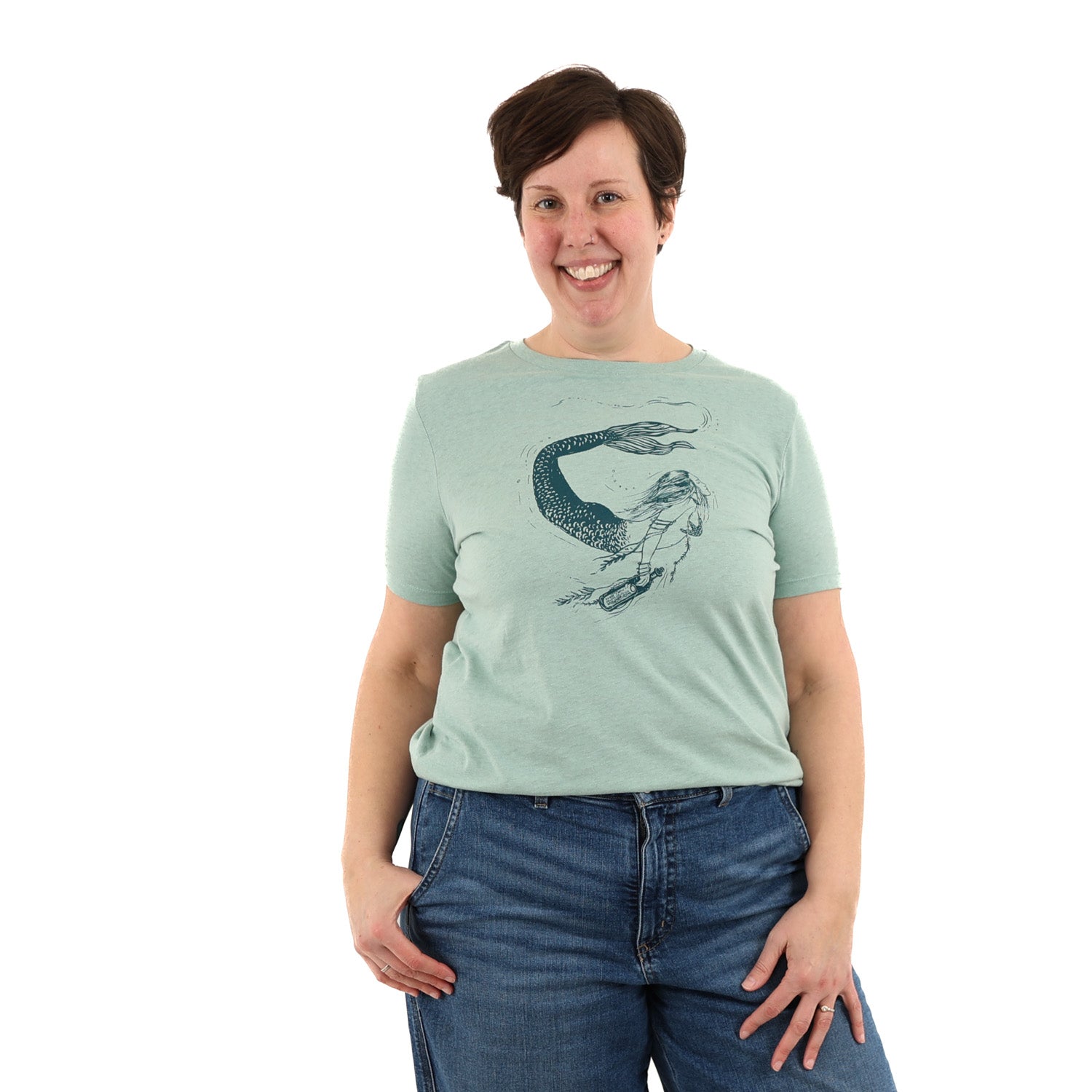 Woman wearing light green t shirt with a mermaid printed in green ink