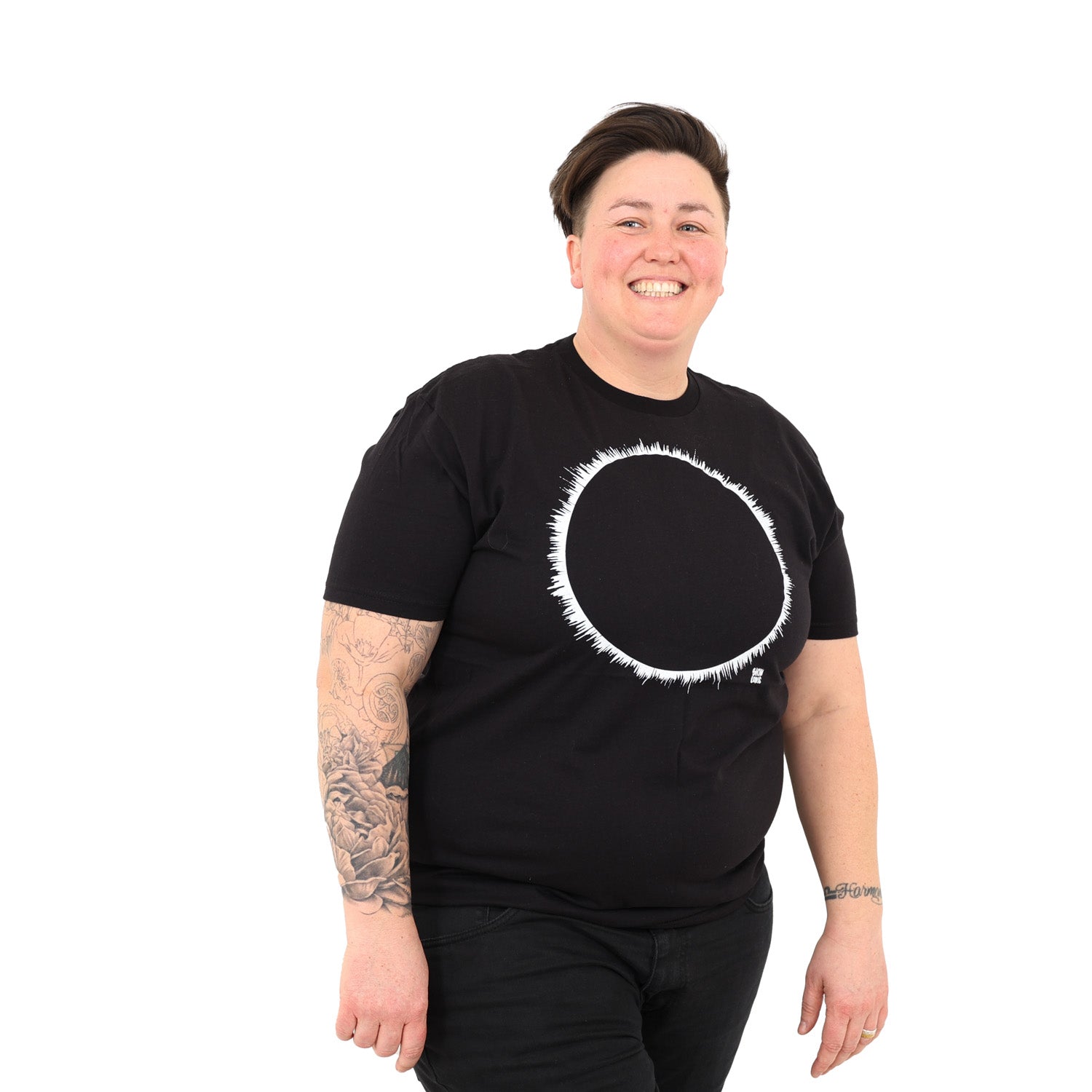 woman with white background wearing a black t-shirt with white eclipse print on it.