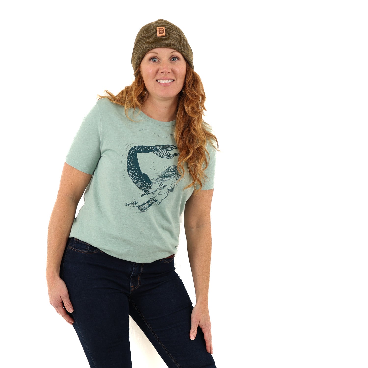 Woman wearing light green t shirt with a mermaid printed in green ink