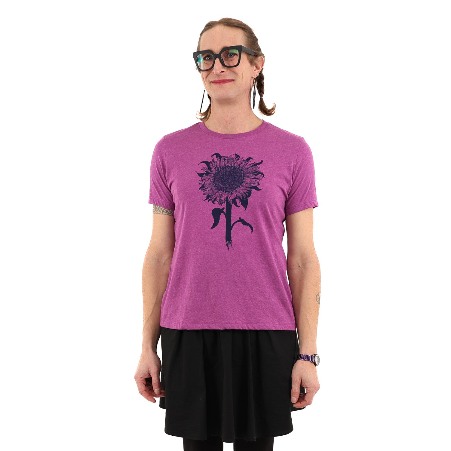 Woman wearing purple tinted pink shirt with a sunflower printed in