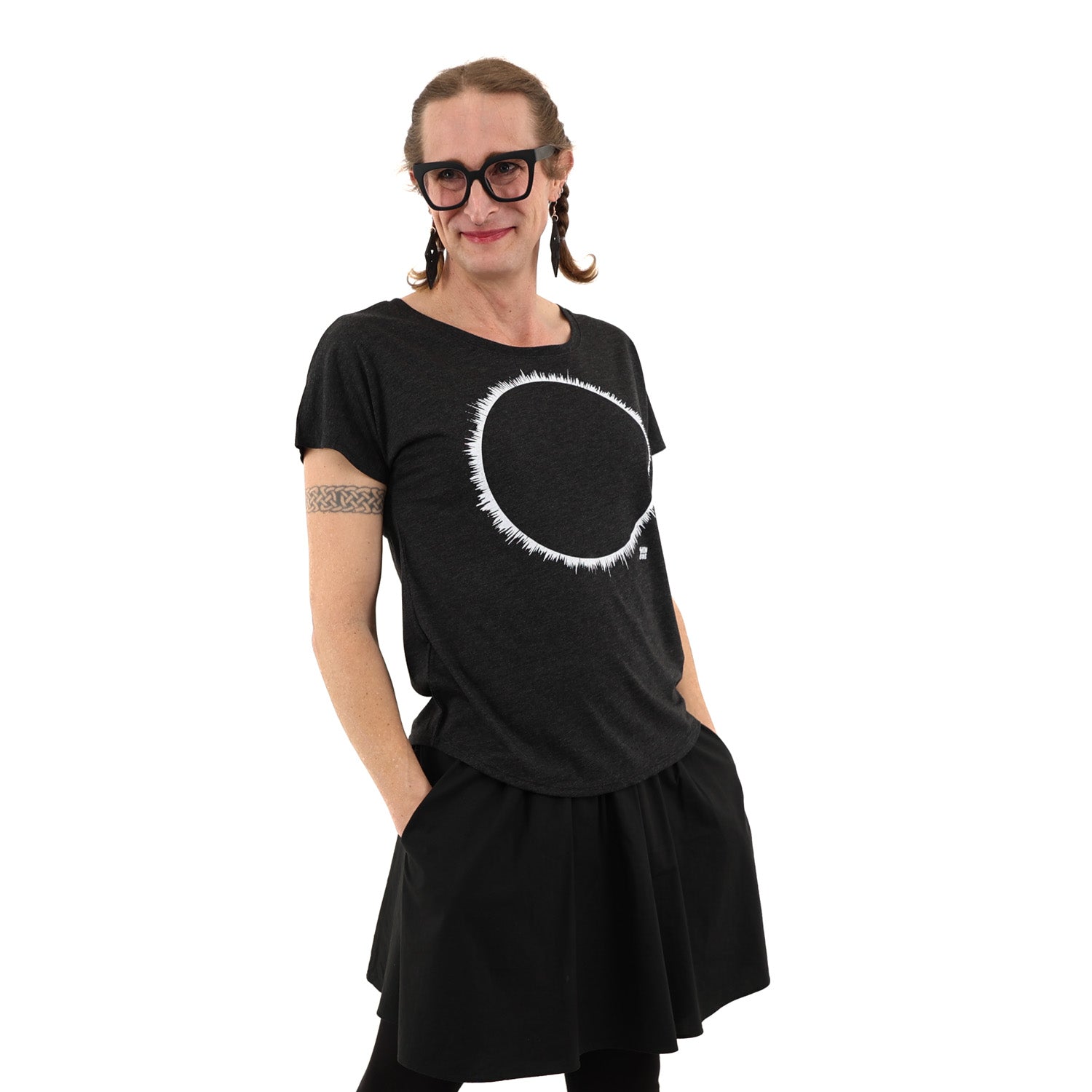 Woman wearing a black t-shirt with white ink of an eclipse.