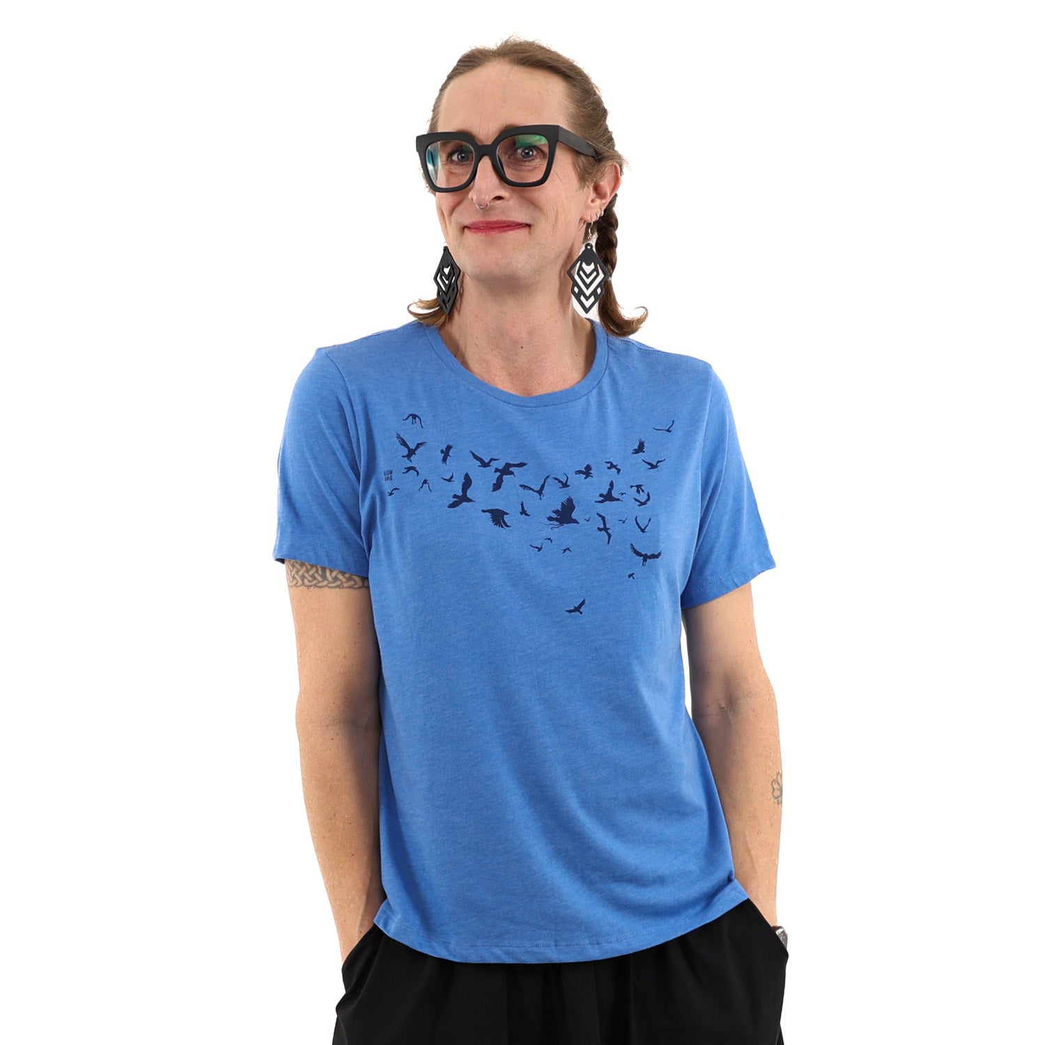 Woman wearing a blue t shirt with birds screen printed across the chest.
