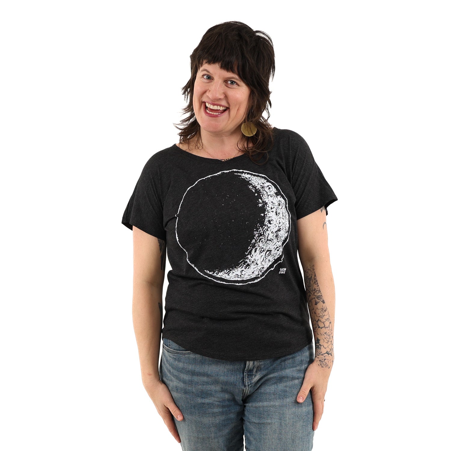 Woman wearing a black t shirt with crescent moon printed in white ink
