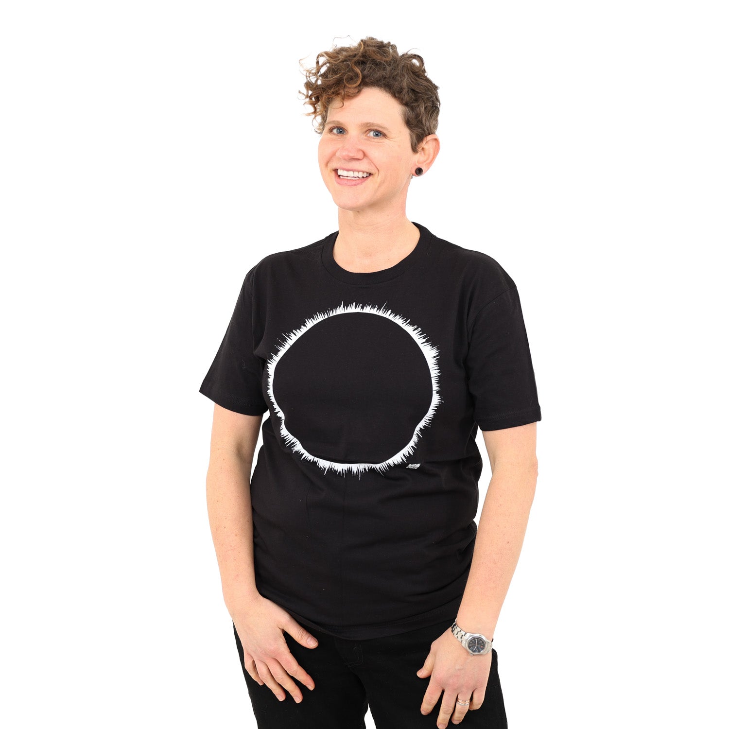 woman with white background wearing a black t-shirt with white eclipse print on it.
