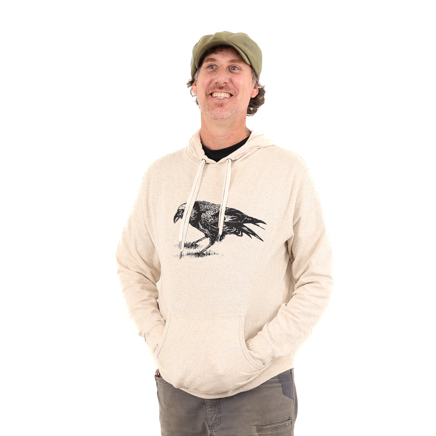 Man wearing tan/white hoodie with a black print of a crow.