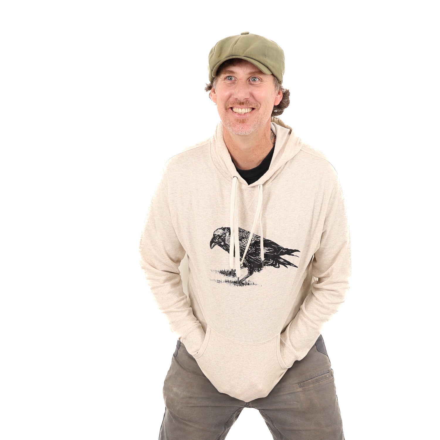 Man wearing tan/white hoodie with a black print of a crow.