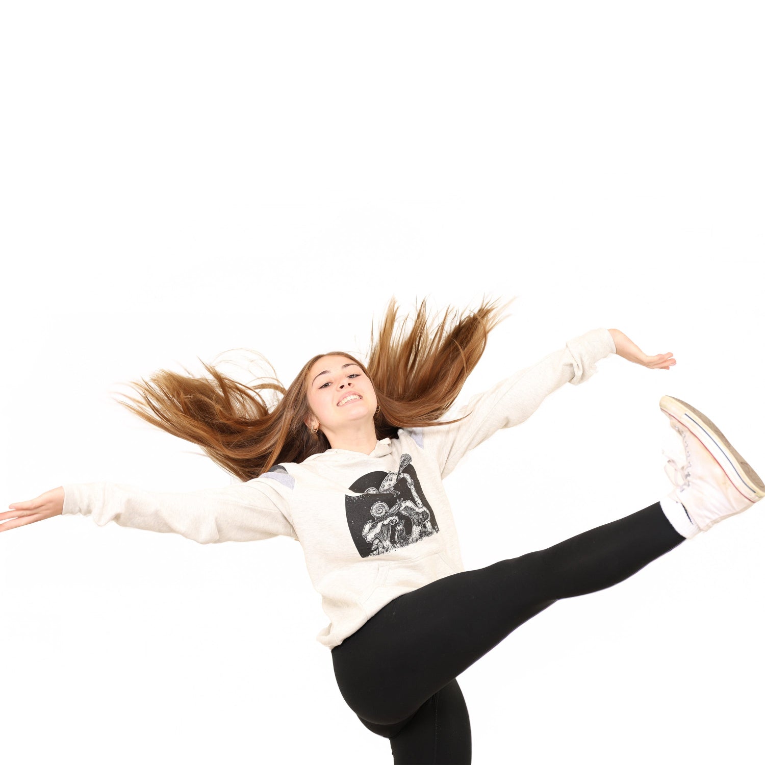 girl with her arms out and kicking her leg up in the air while wearing a slow loris full moon buffet hoodie