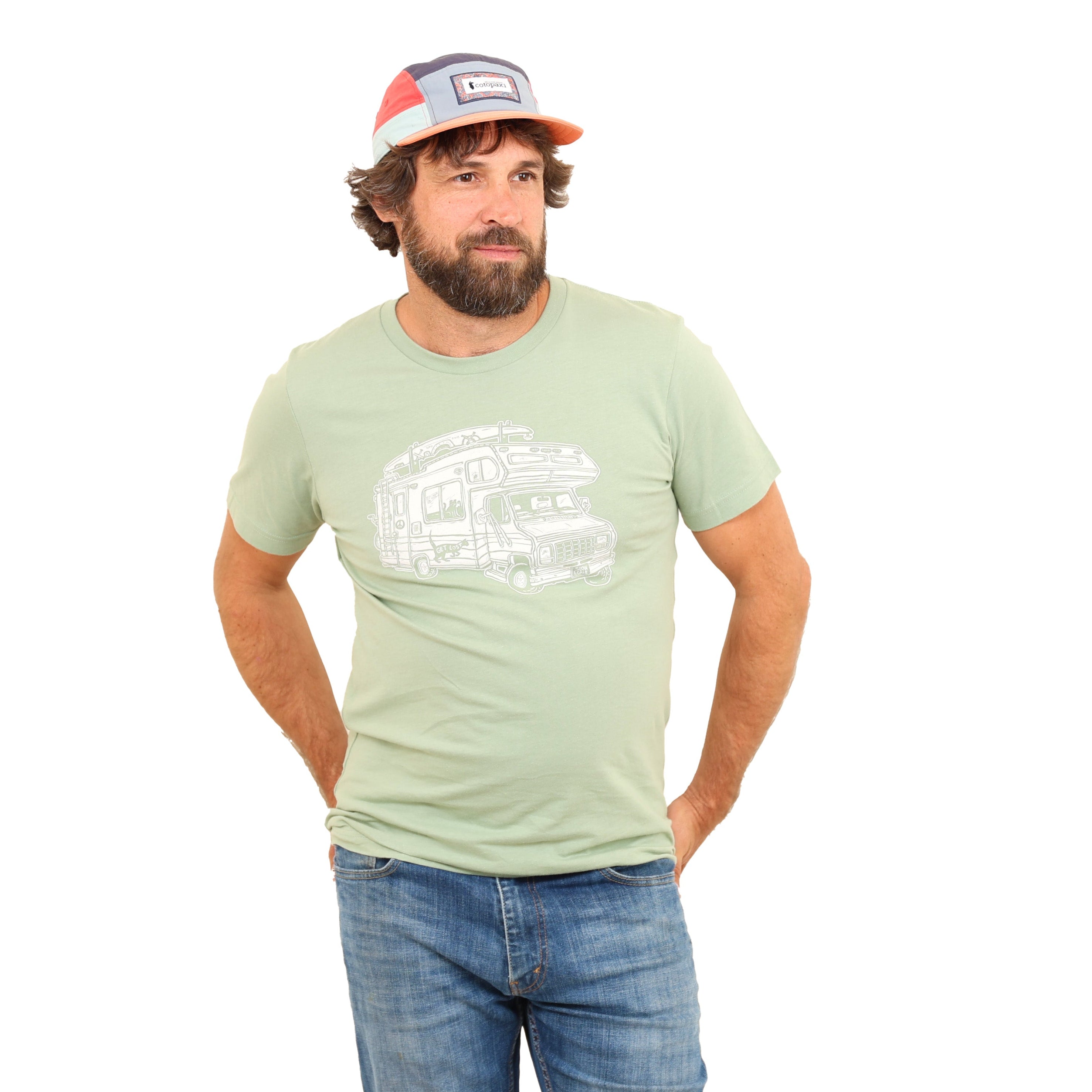 Man in white backdrop with sage green t shirt with a white print of a camper