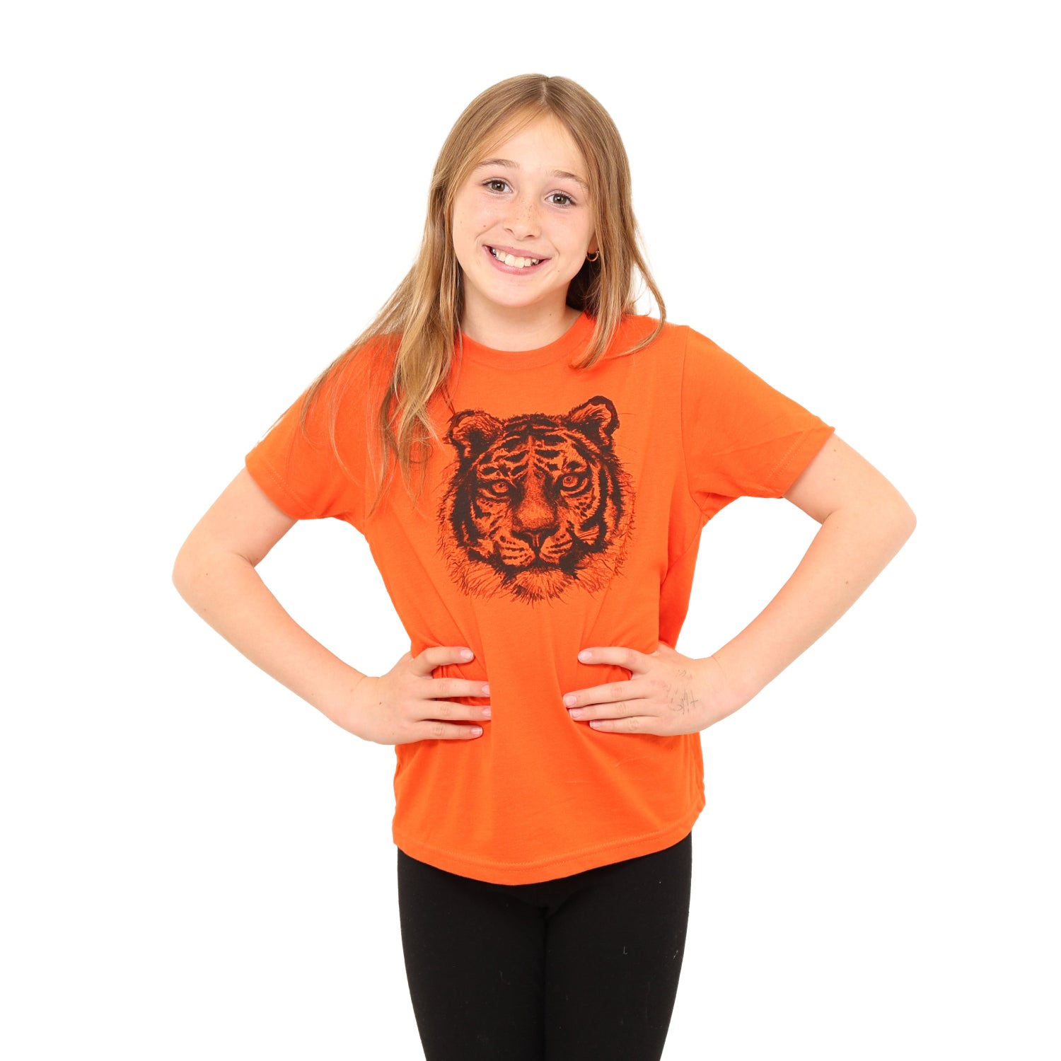 girl smiling wearing orange t with tiger.