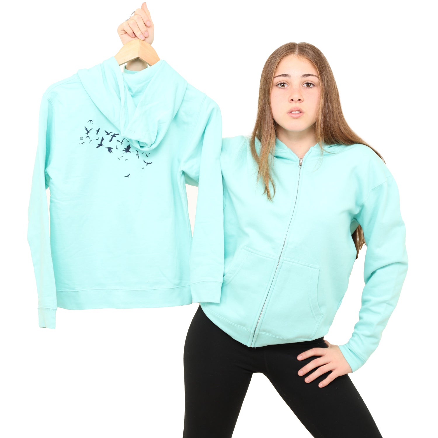 girl holding up the back of the hoodie while wearing one herself