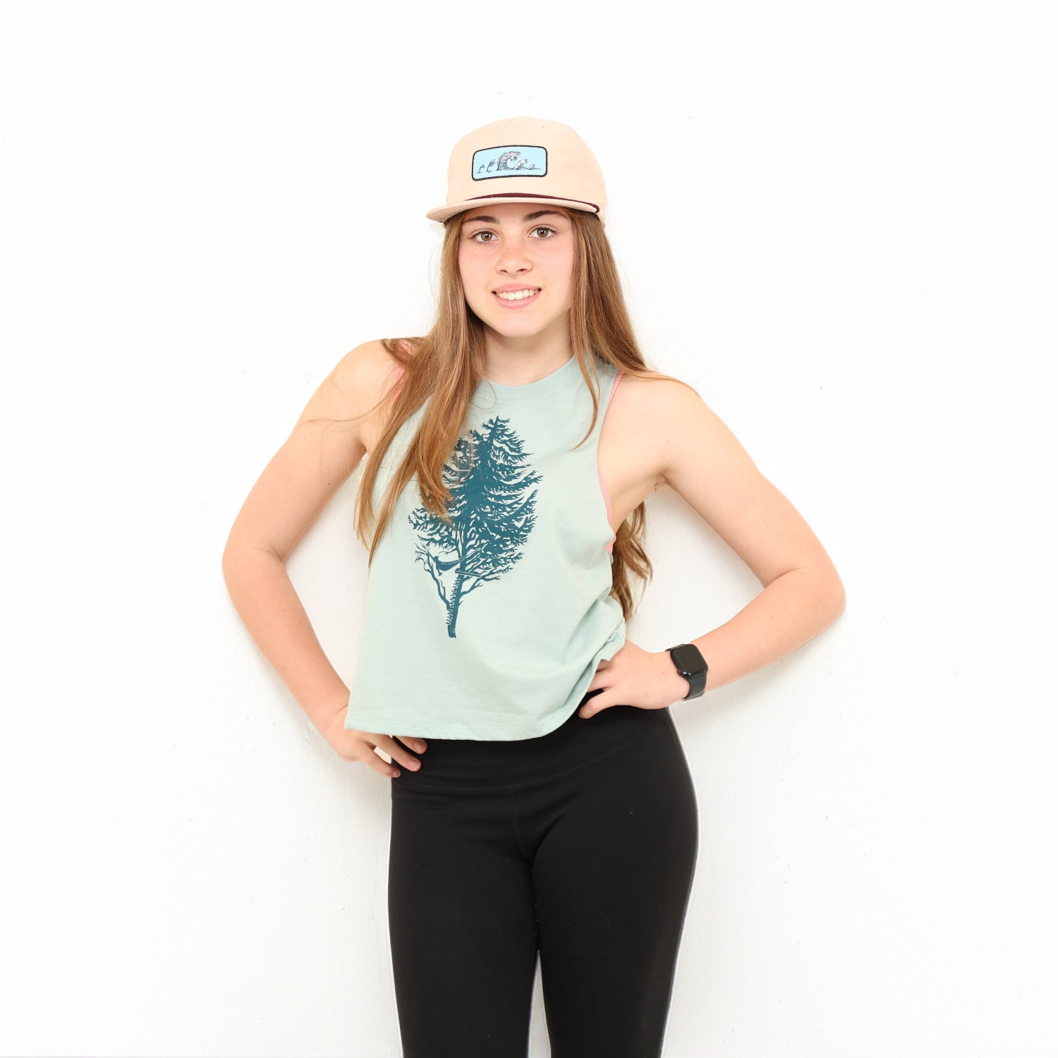 Girl wearing tank and hat with white background