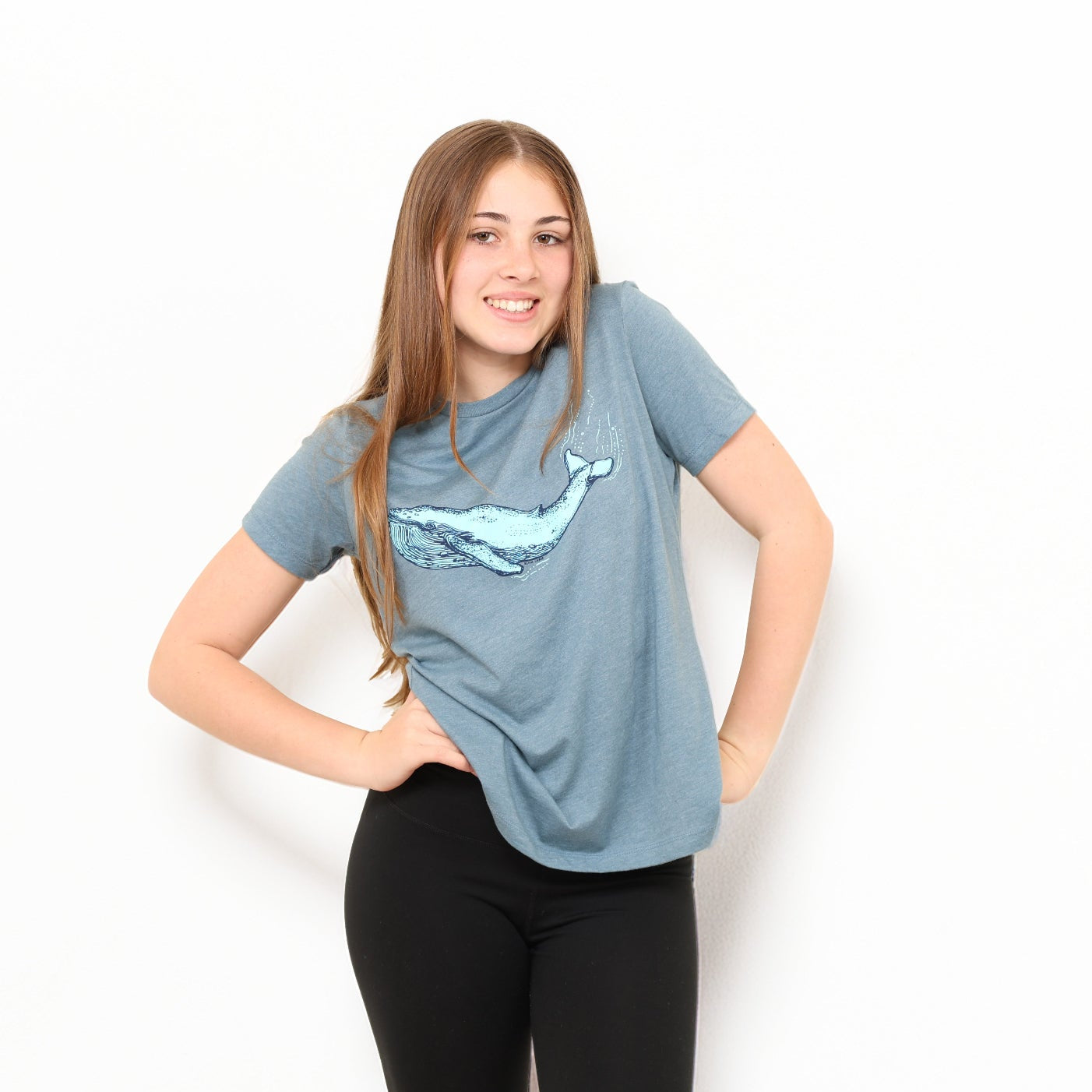 girl wearing blue whale t shirt in white background
