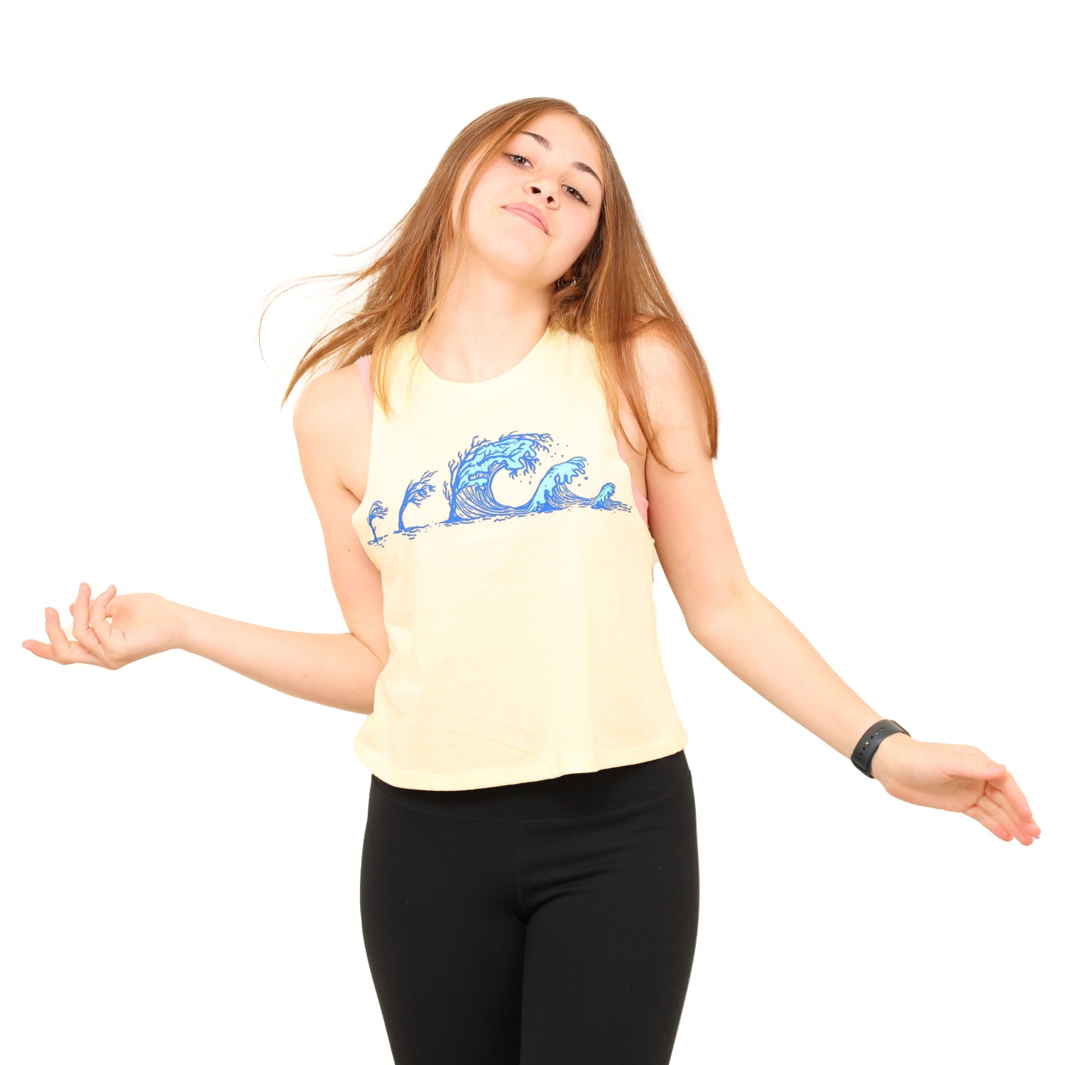 girl with hands out and head kicked back while wearing a soft yellow tank with tree wave print