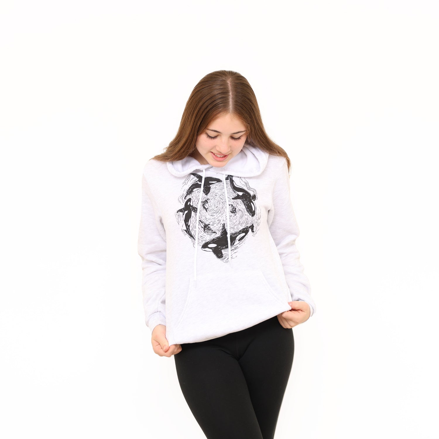 Girl standing in a white background wearing a slow loris unisex orca pod pullover hoodie
