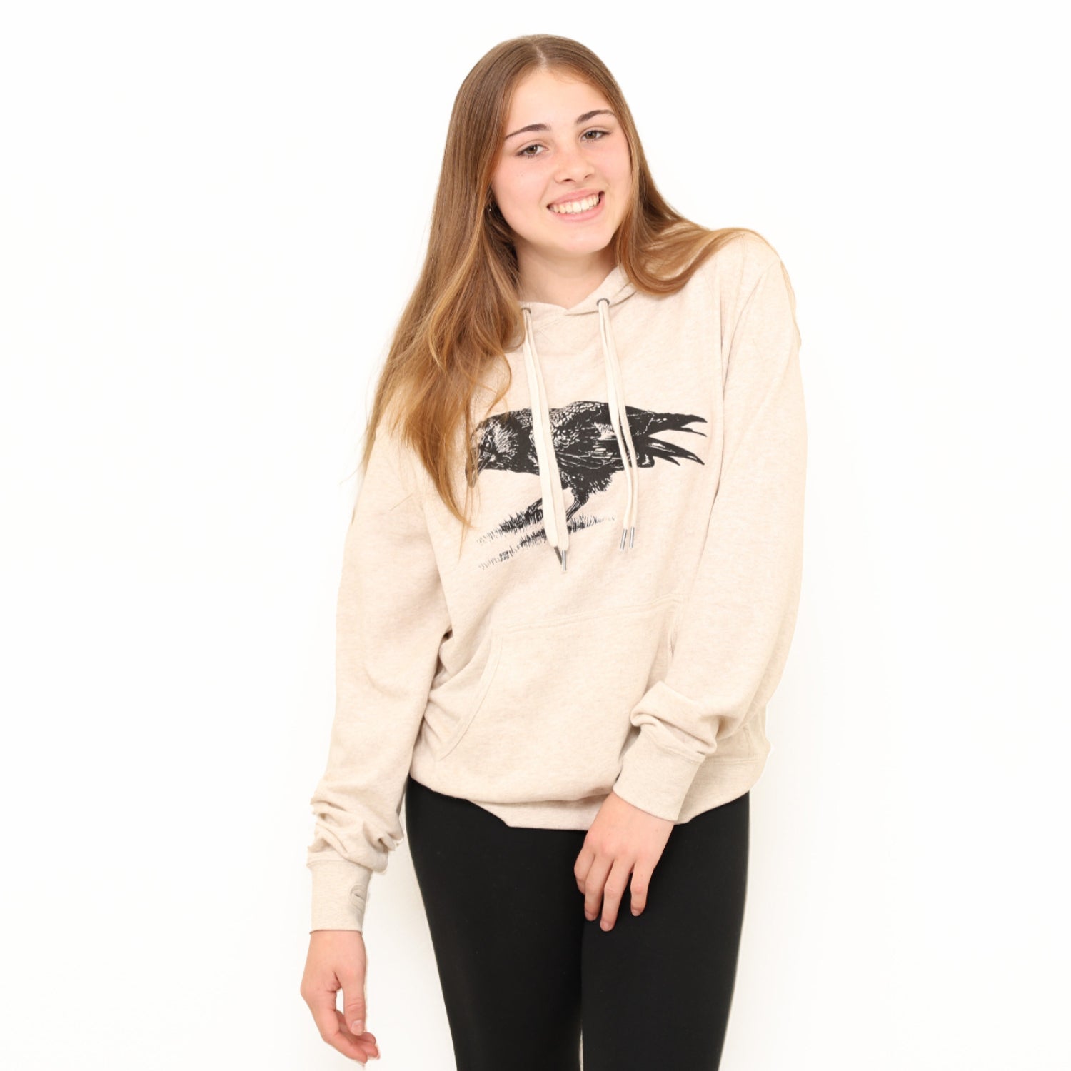 Girl standing in a white background wearing a slow loris Unisex crow pullover hoodie