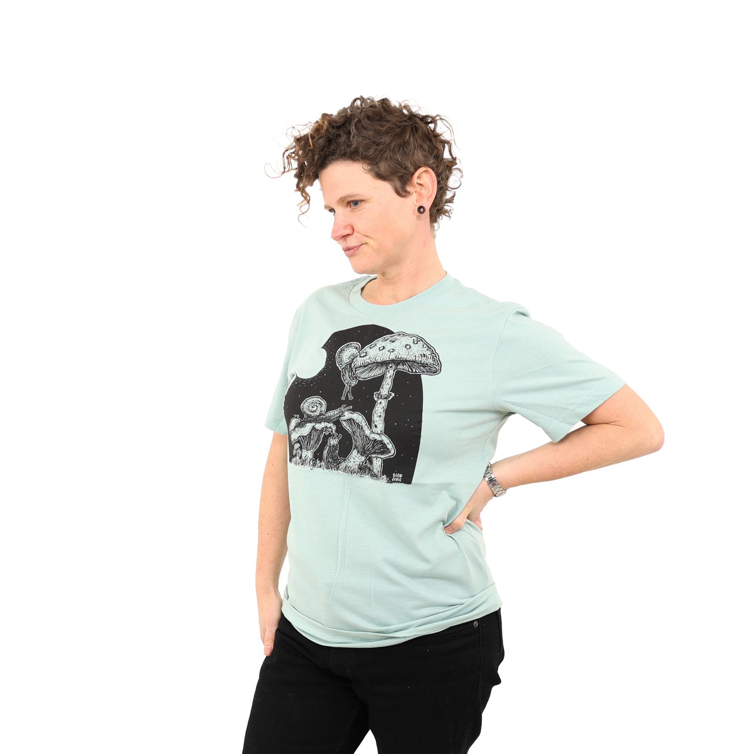 woman wearing light mint shirt with snails eating mushrooms in the full moon light.