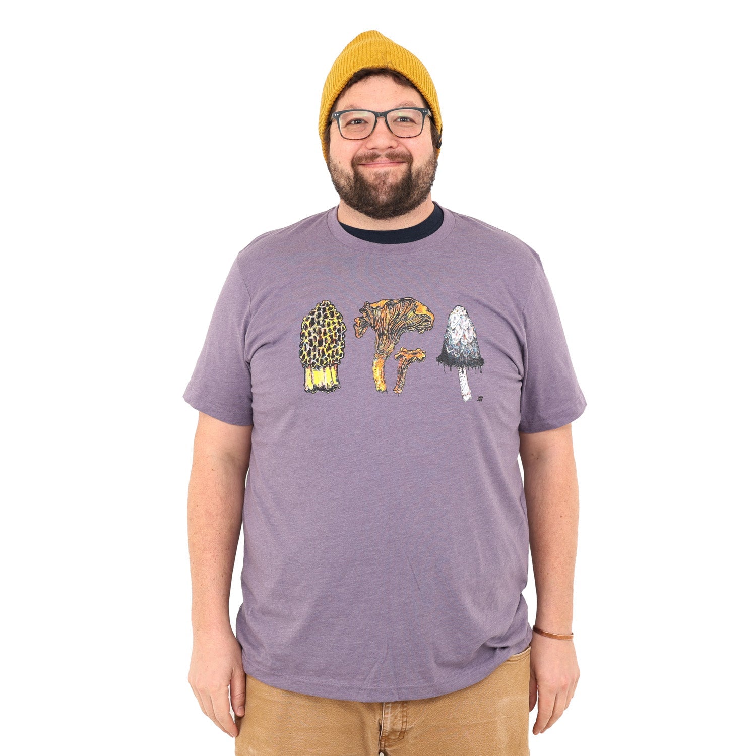 man wearing a light purple colored shirt with three mushrooms- morel, chantrelle, and shaggy mane