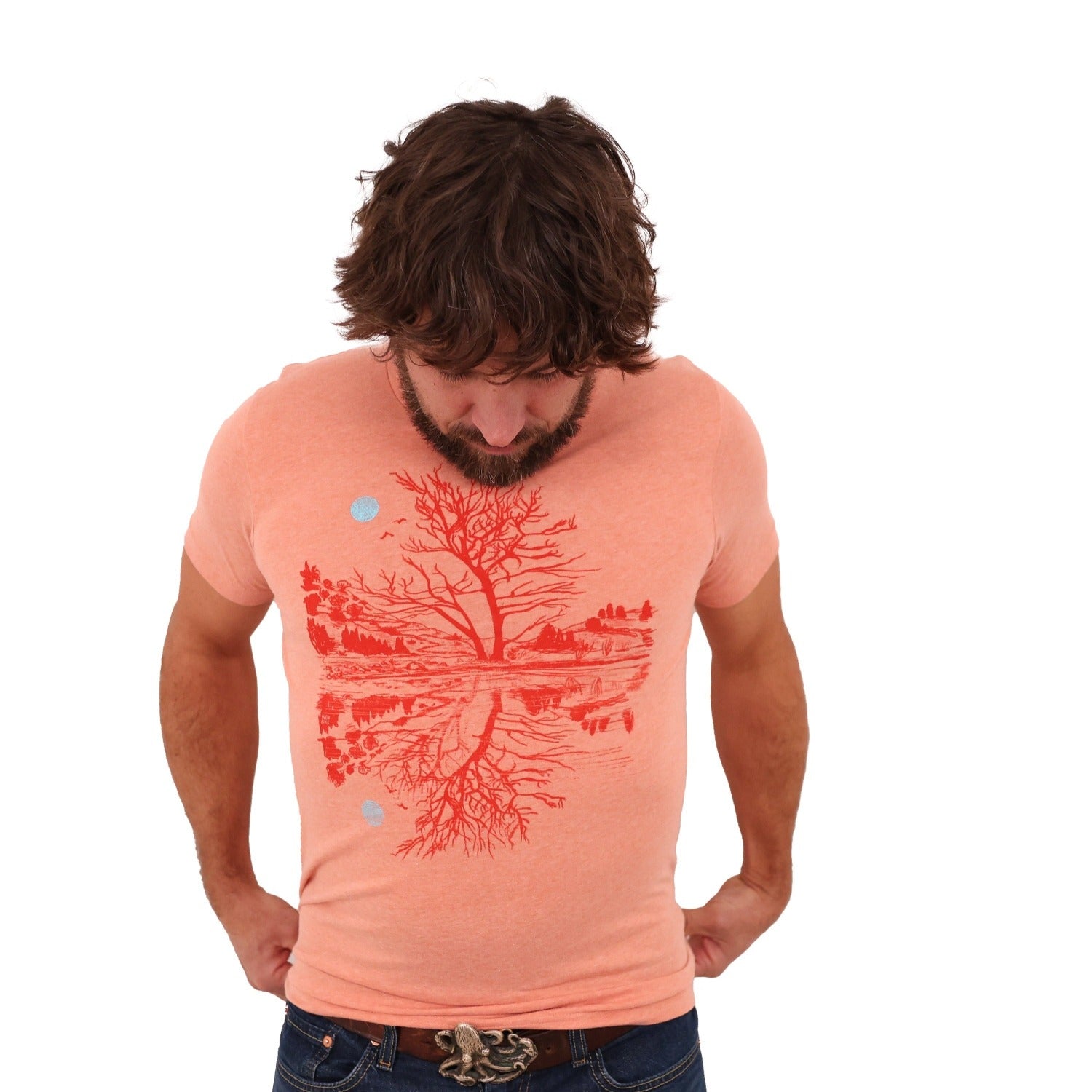 man wearing sunset orange t-shirt with darker orange print of moon and scene reflection over water.