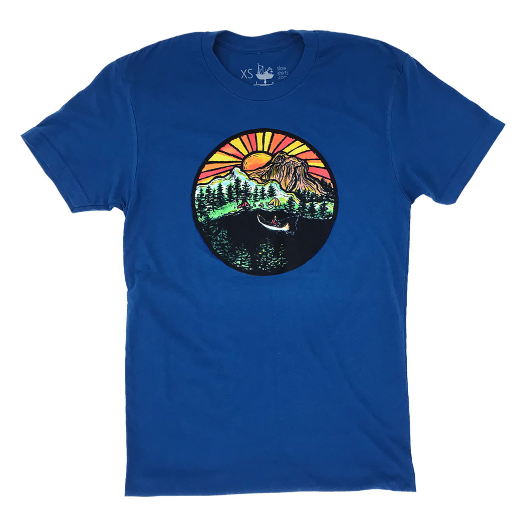 blue shirt with a multi-colored print of sunsetting behind the mountains, and a canoe lake scene.