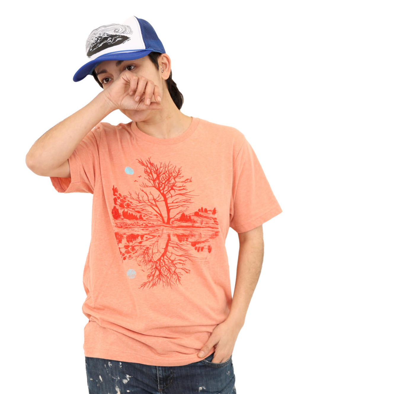 woman wearing sunset orange t-shirt with darker orange print of moon and scene reflection over water.