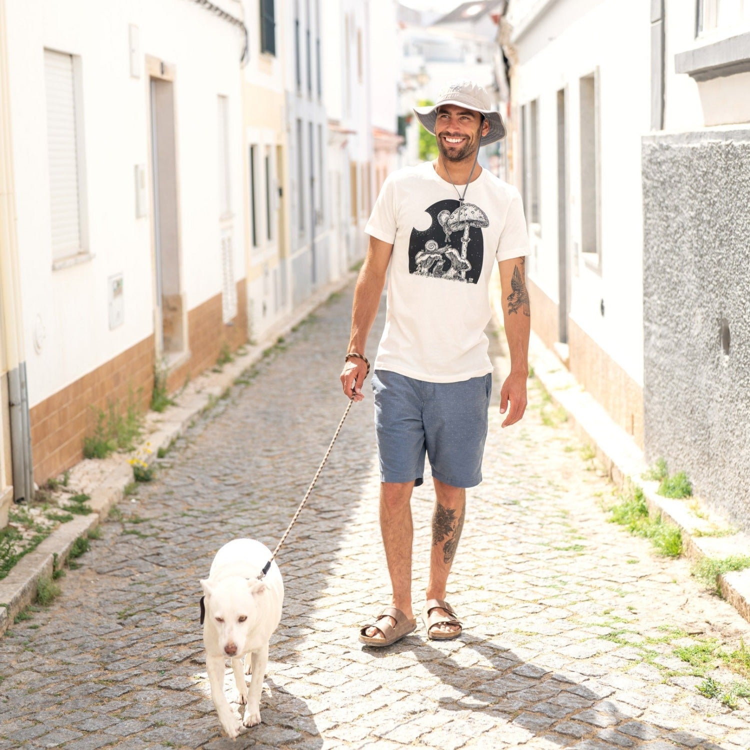 man walking dog while wearing a white shirt with snails eating mushrooms in the full moon light.