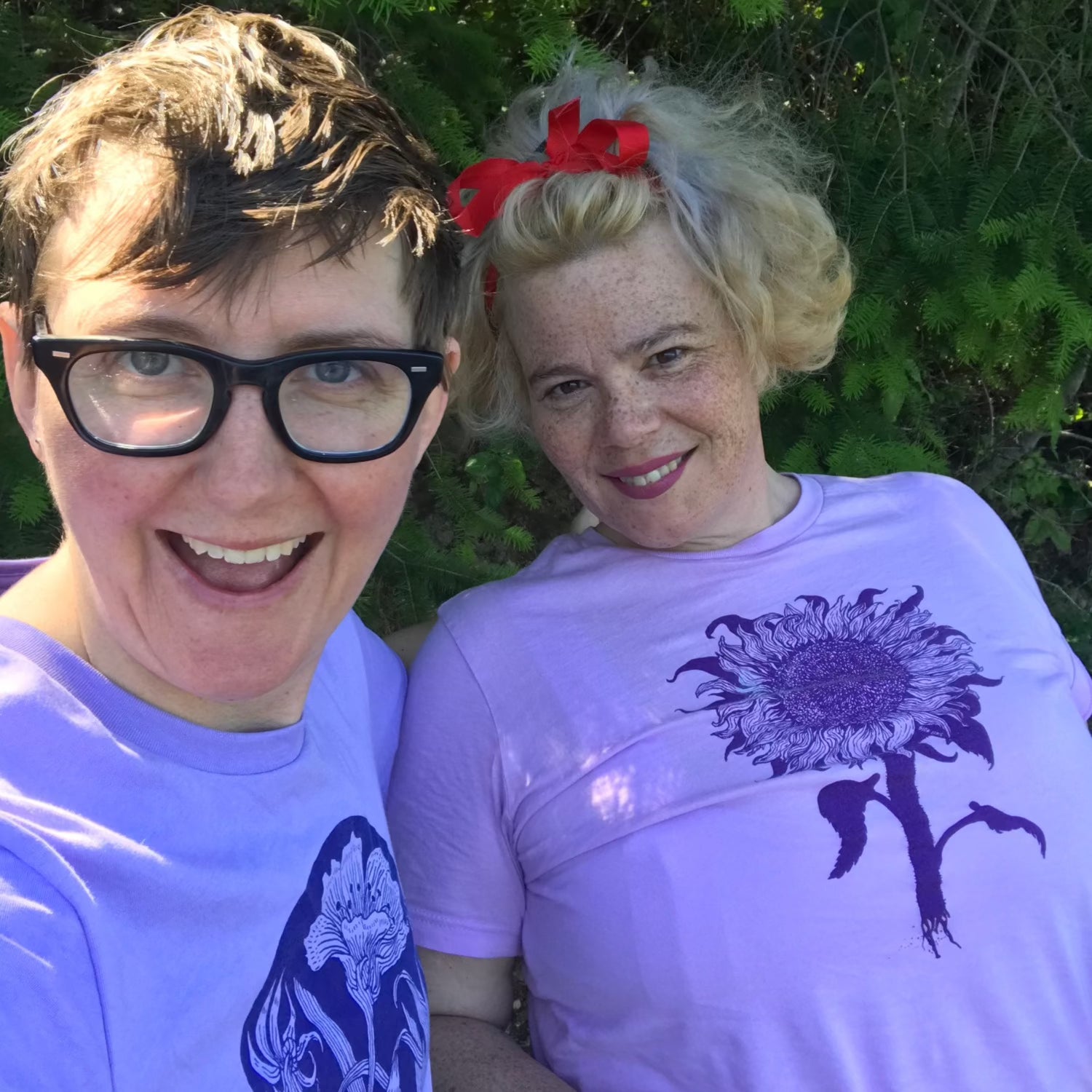 a couple sitting together while one is wearing sunflower t-shirt.