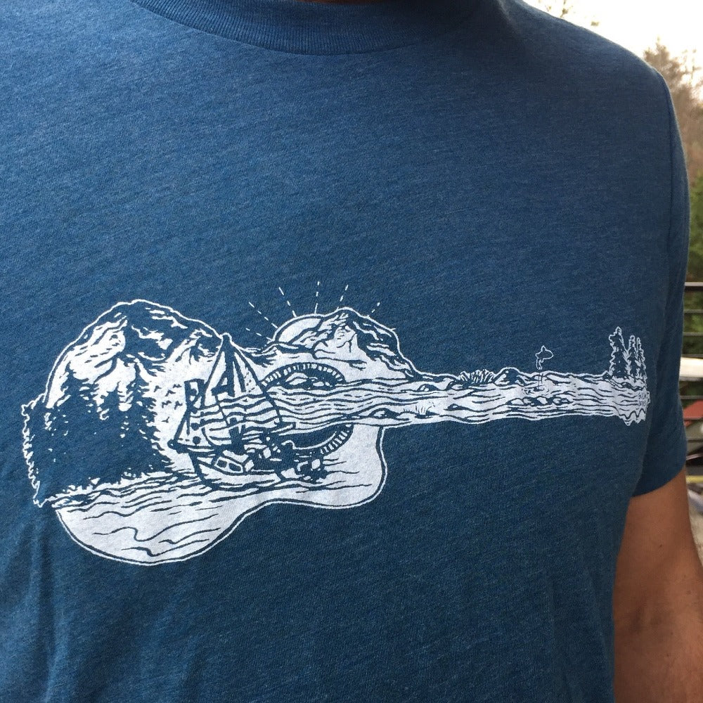 mountain, water, boat scene in the shape of a guitar