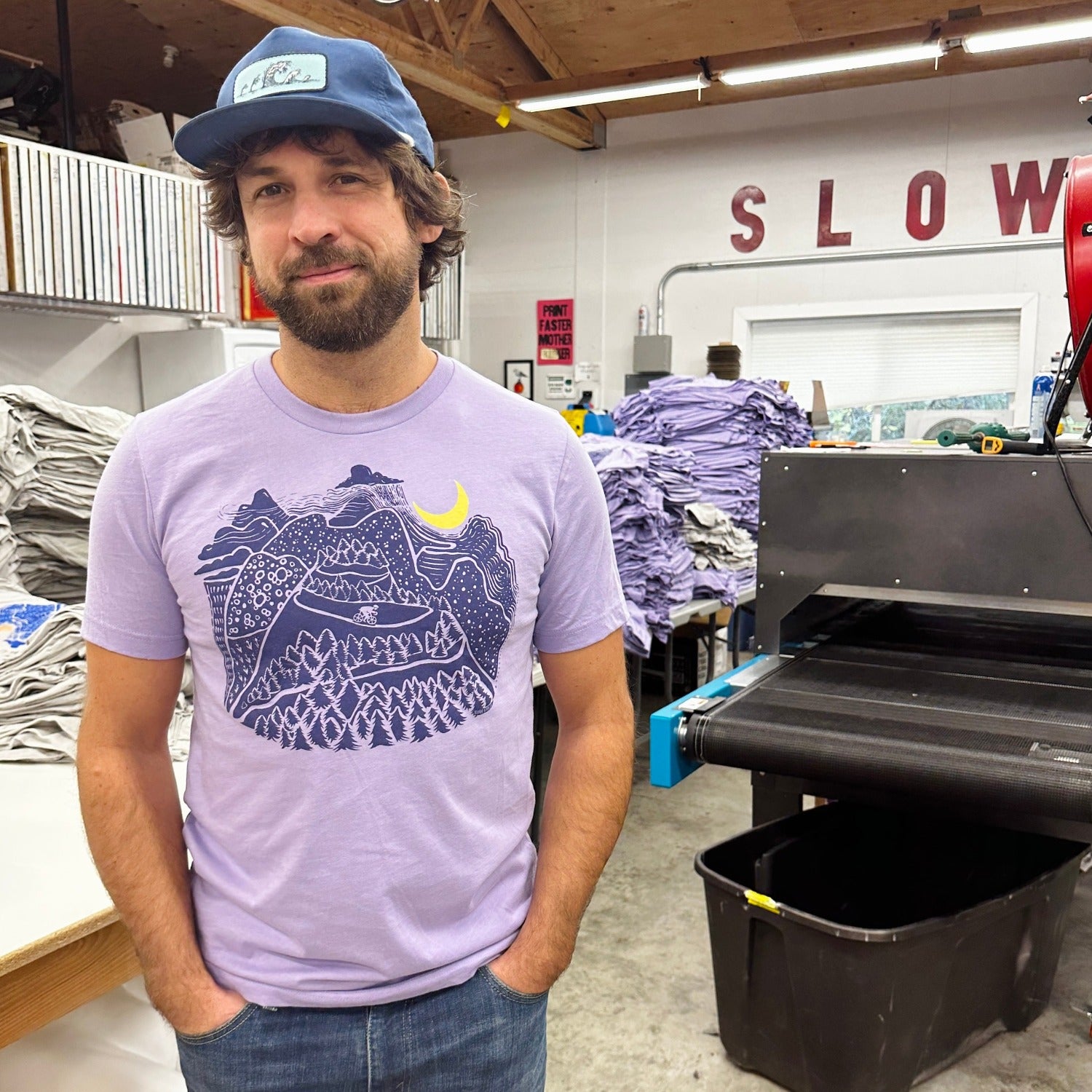 Man smiling while wearing Slow Loris Night Ride T shirt