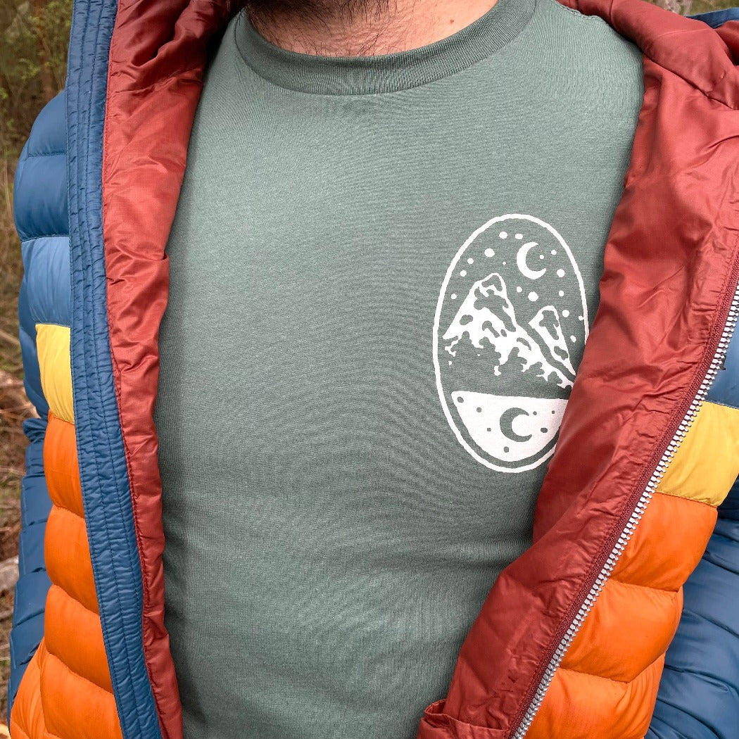 Green t shirt printed with a small nighttime landscape on the left breast. This is the front of the Backpacker t.