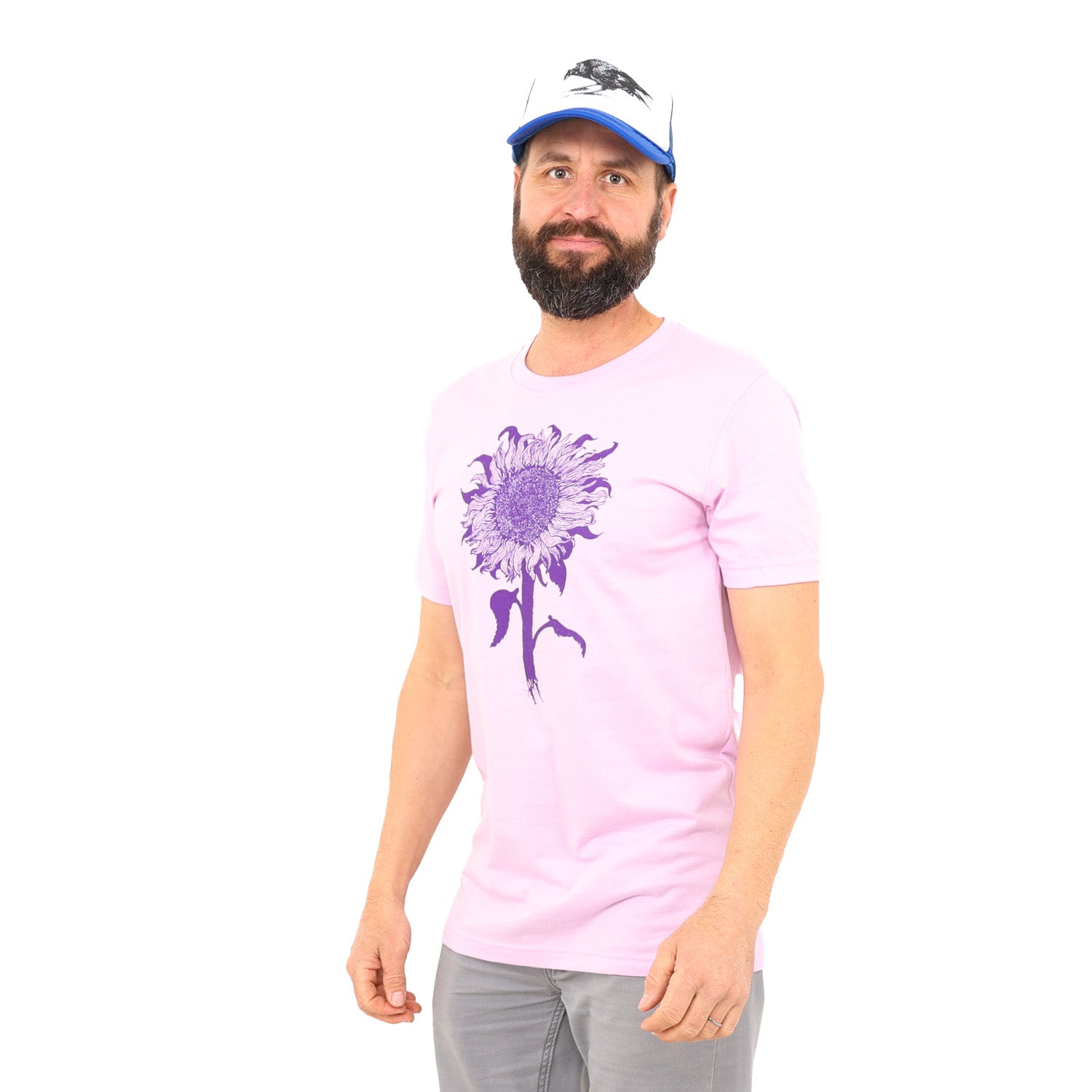 man standing in white background while a pinkish/purple t-shirt with dark purple ink of an intricate sunflower