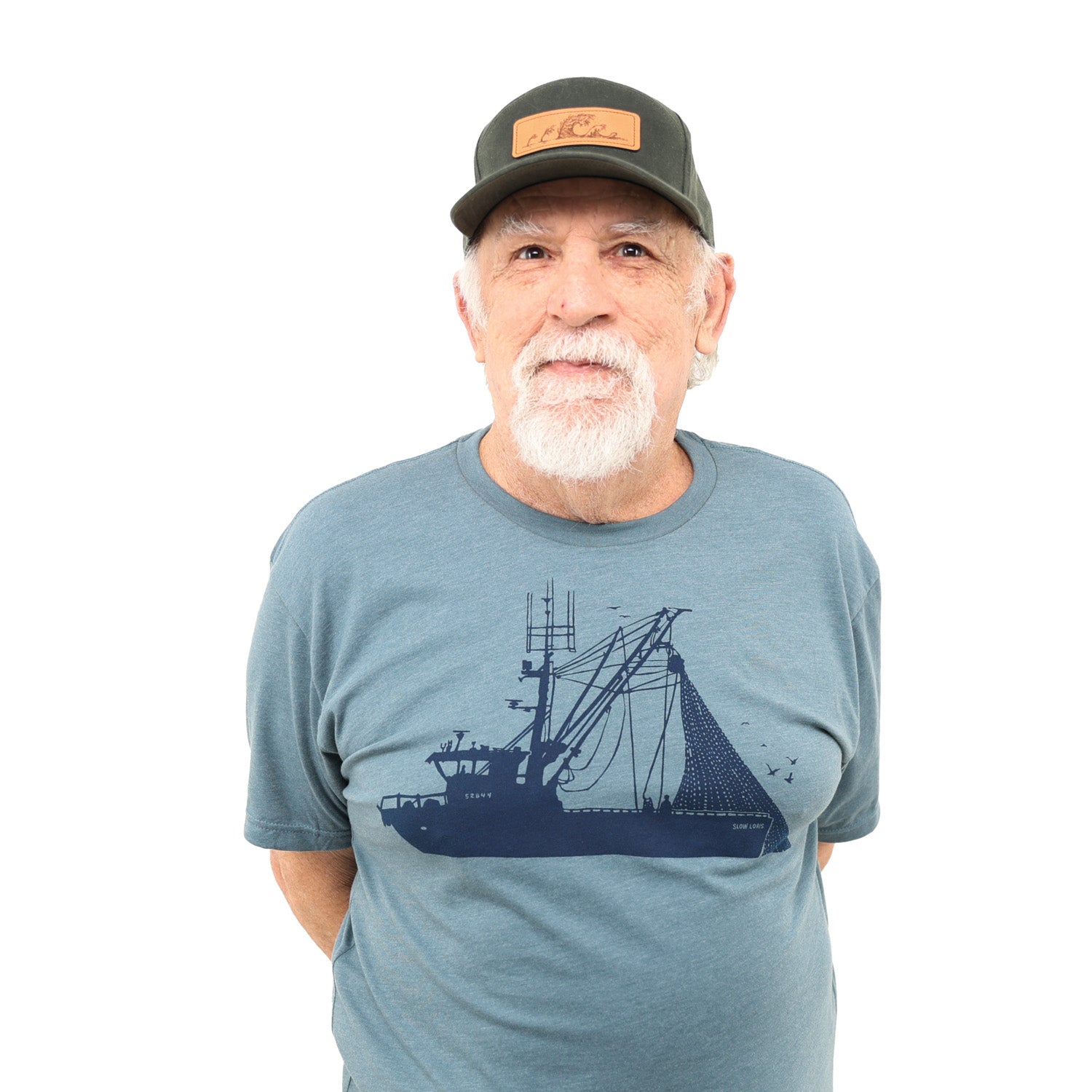 Closer view of man wearing ball cap and light blue shirt with dark blue ink of a seiner