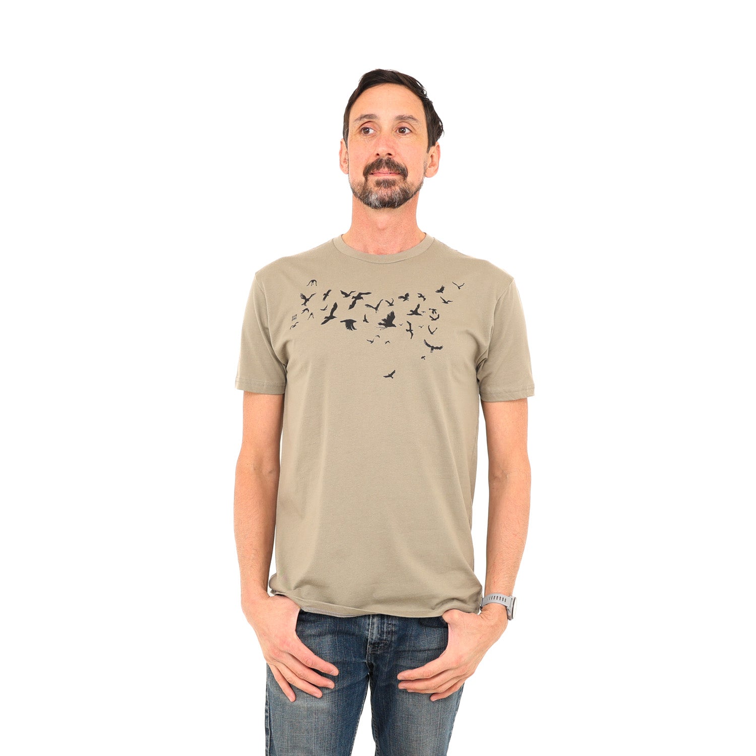 man wearing light brown/tan-ish t-shirt with black ink of birds flying across his chest