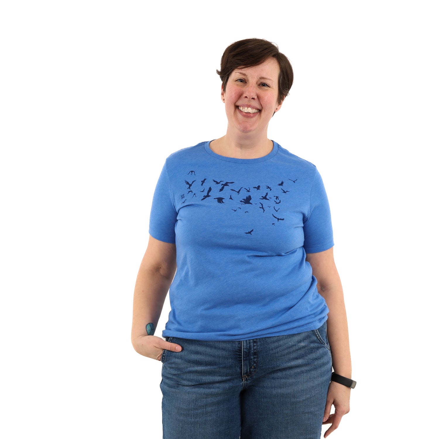 Woman wearing a blue t shirt with birds screen printed across the chest.