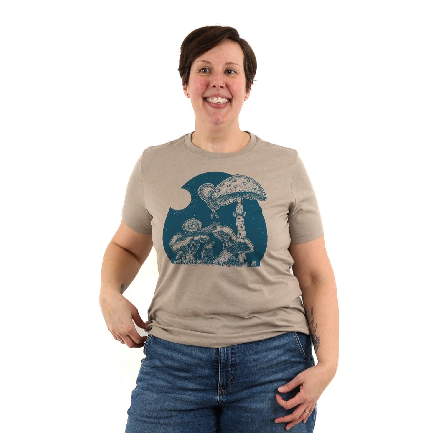 woman wearing tan/brown colored t shirt with blue ink of the full moon buffet slow loris t shirt.