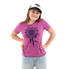Young girl wearing purple tinted pink shirt with a sunflower printed in 