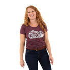  Woman wearing maroon shirt with a drawing stormy seas printed in white -