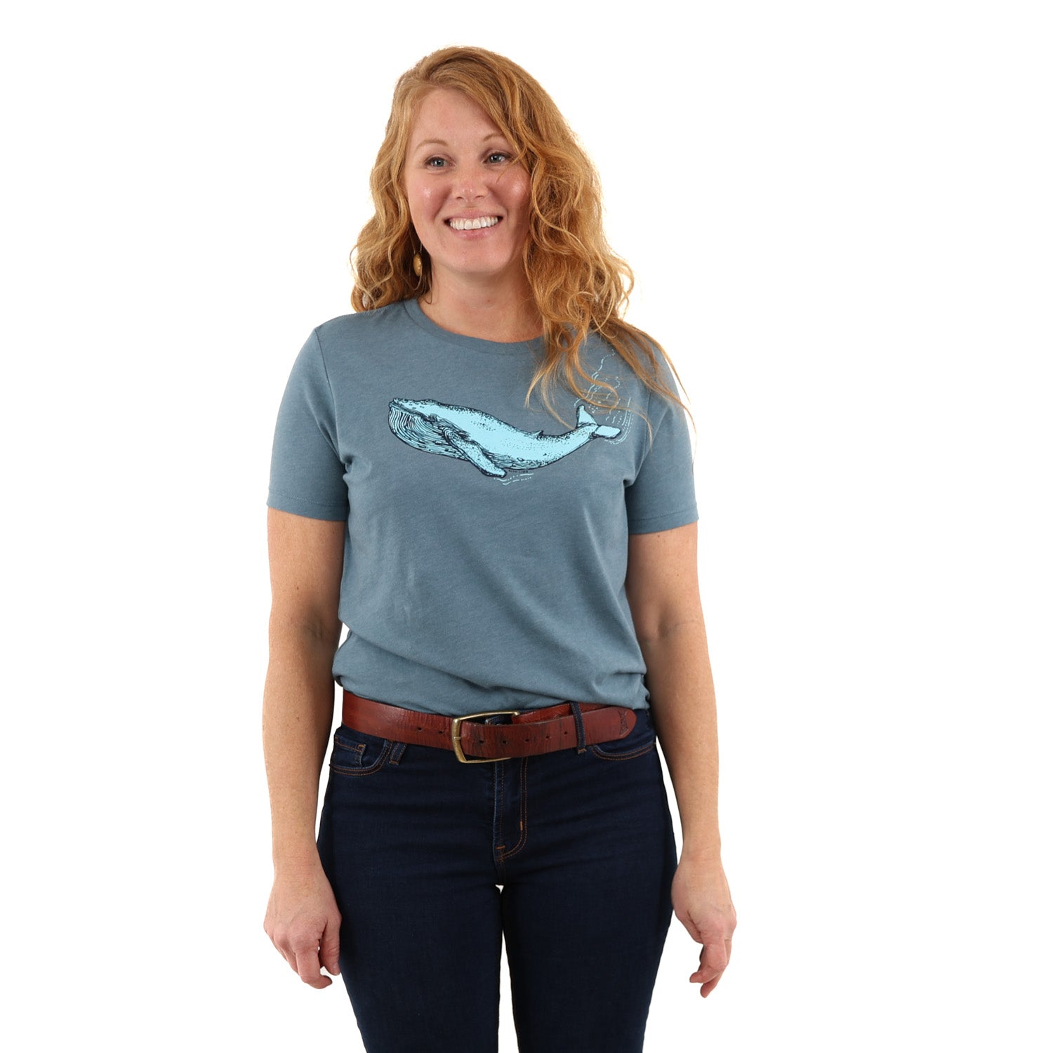 woman standing while wearing a blue t shirt with a blue whale screen printed across the chest/boob zone.