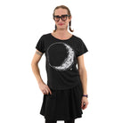 Woman wearing a black t shirt with crescent moon printed in white ink