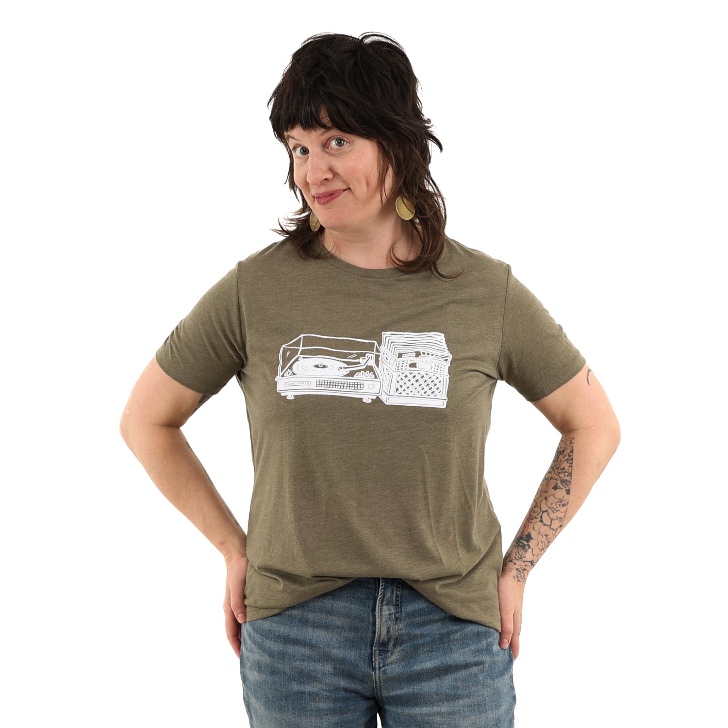  Woman wearing olive green brown t shirt with turn table and milk crate full of records in white ink