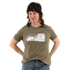 Woman wearing olive green brown t shirt with turn table and milk crate full of records in white ink