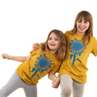two little girls, one with her arm around the other, both wearing a mustard colored t-shirt with light blue print of an intricate sunflower.