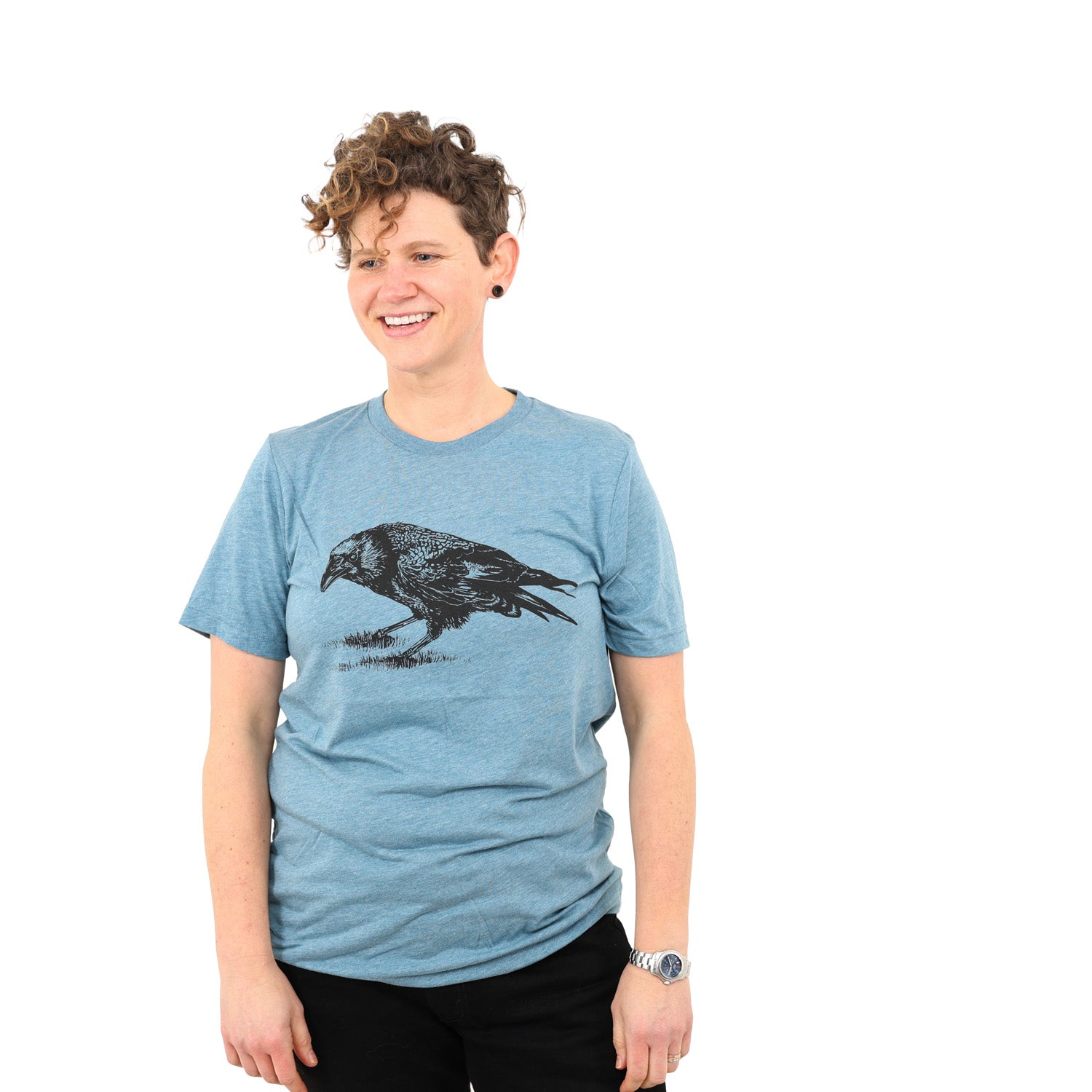 Women wearing blue shirt with black ink printed crow. 