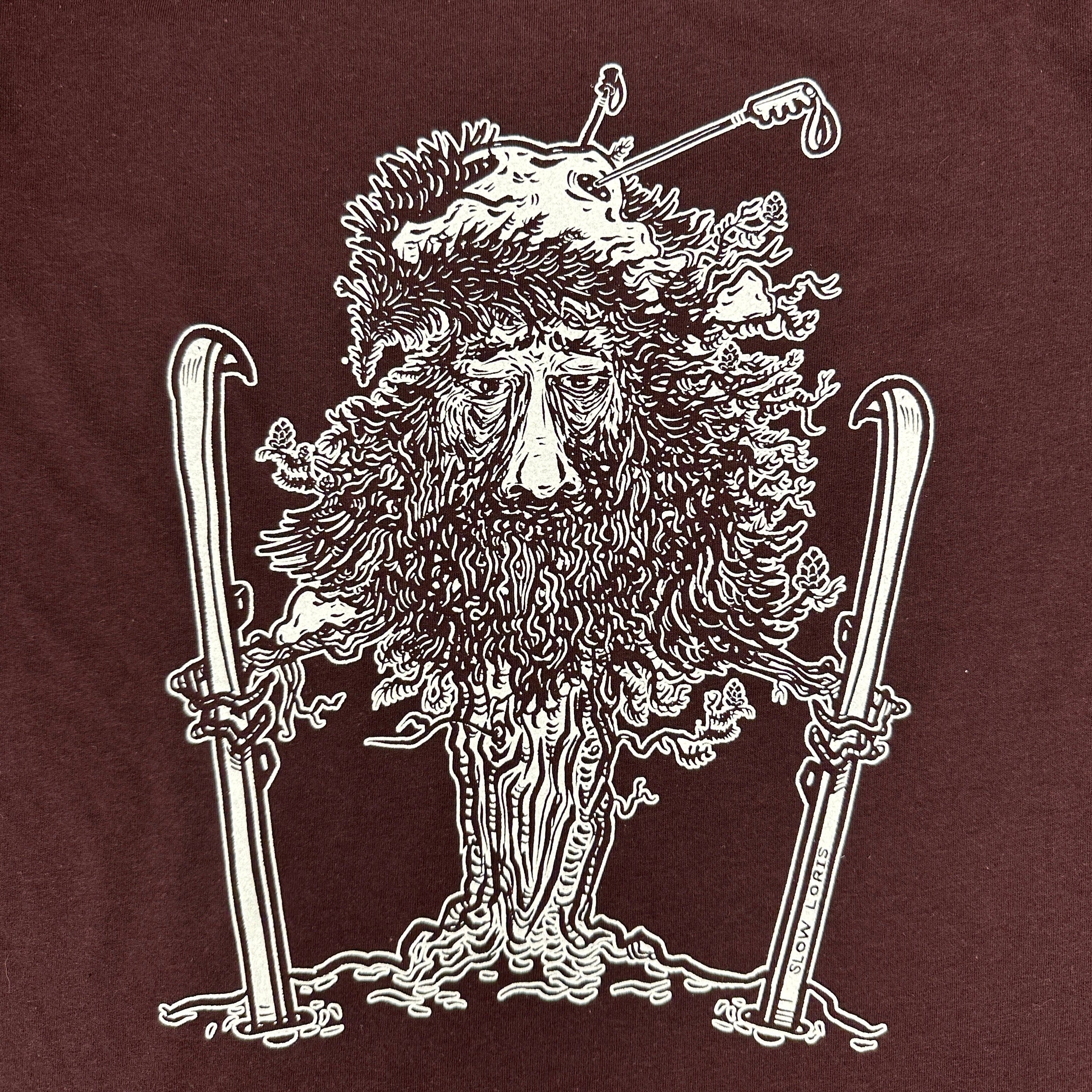close up of tree man holding skis with ski poles in his top branches