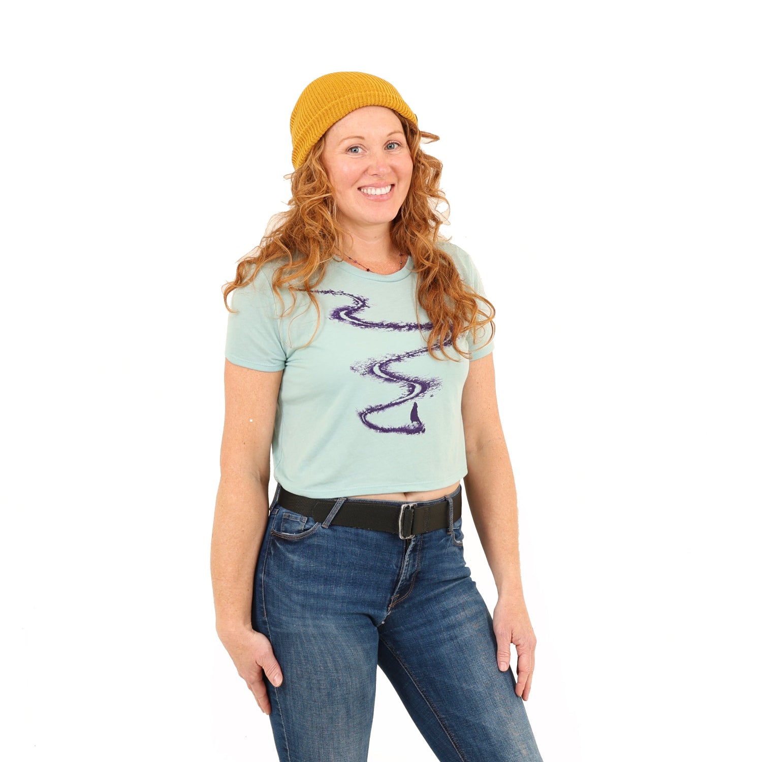 Girl wearing yellow hat and blue shirt with a ski line and a skier/snowboarder at the bottom