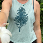 girl wearing tank holding out flower